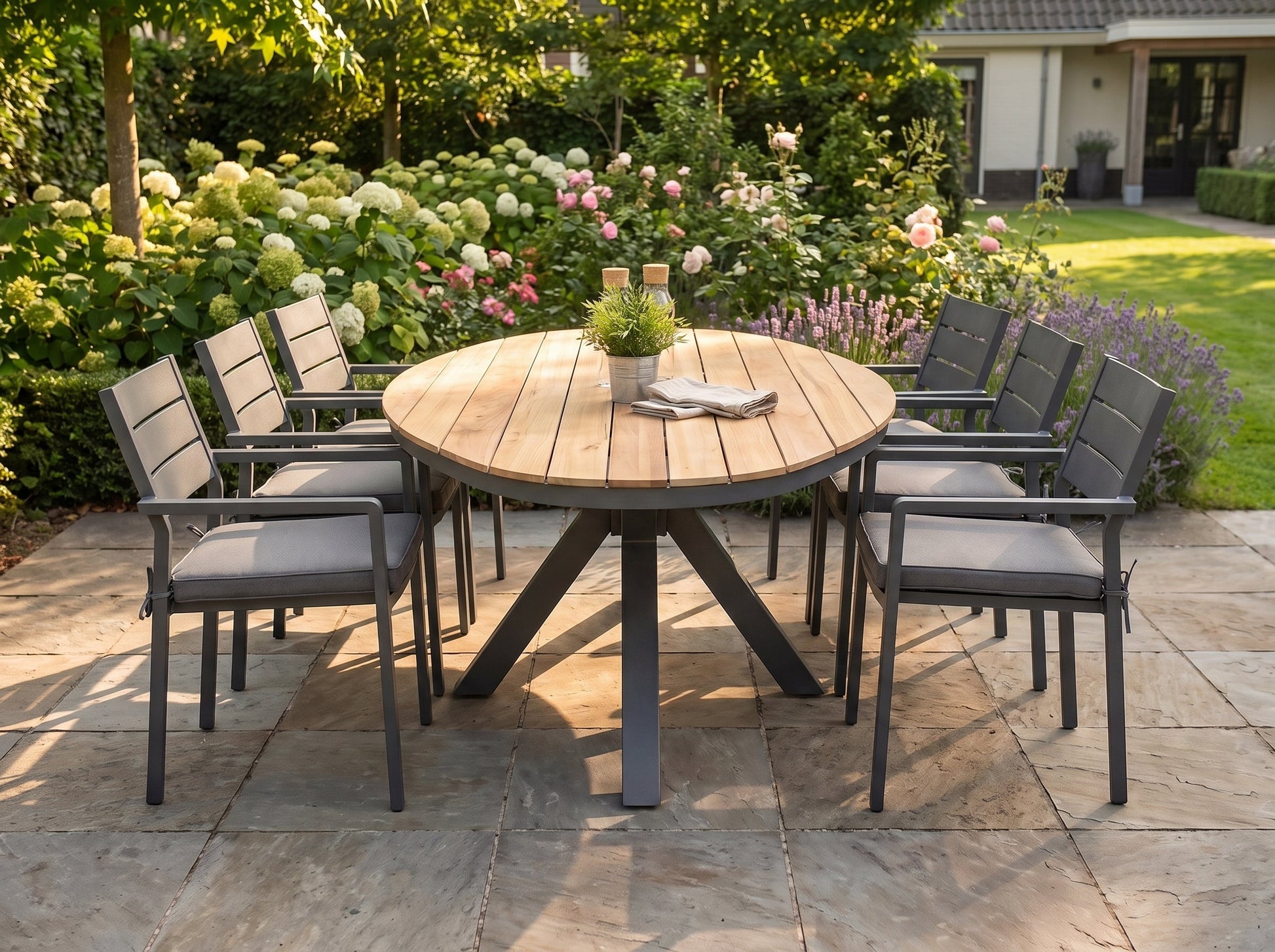 Akron-Bolton Tuinset 6 Personen - Teak / Dark Grey in einem stimmungsvollen Garten - Outnest Gartenmöbel